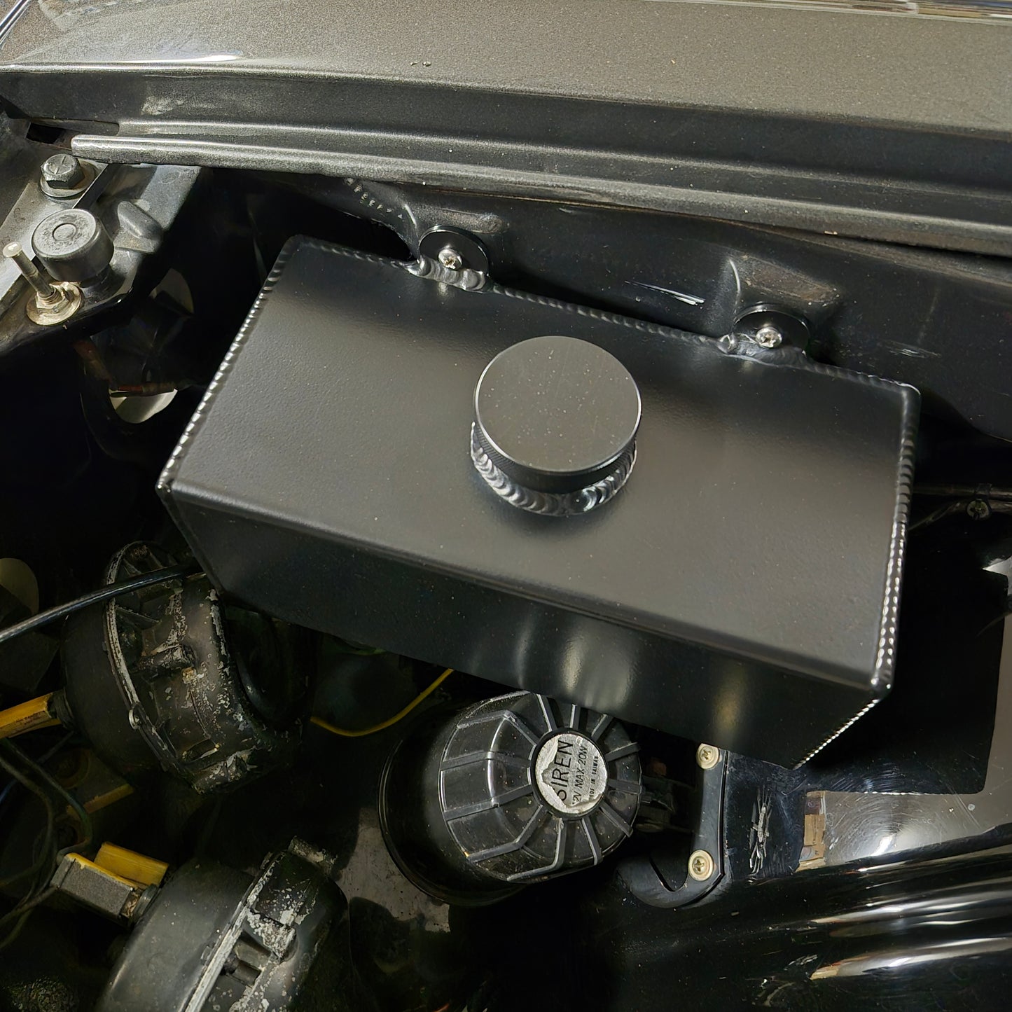 Close-up of a Windscreen Washer Bottle.