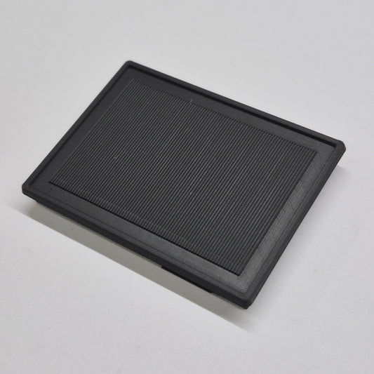 Black rectangular solar panel on a light gray background