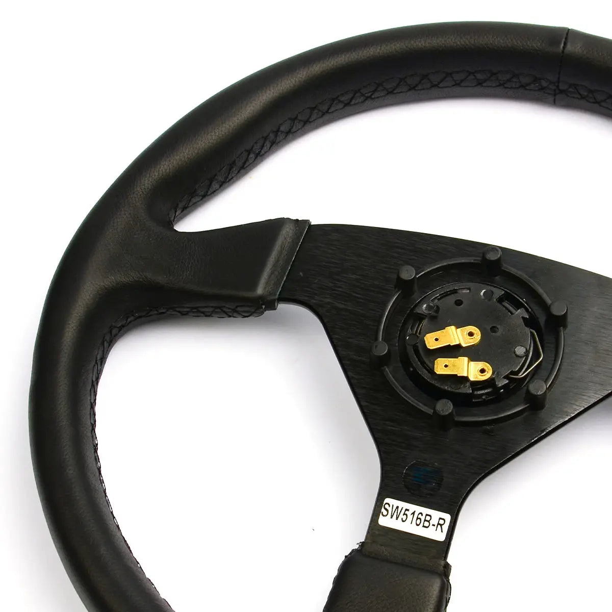 Black steering wheel with gold accents on a white background