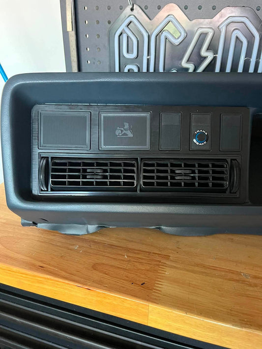 Car air conditioning vent on a wooden surface with a pegboard in the background