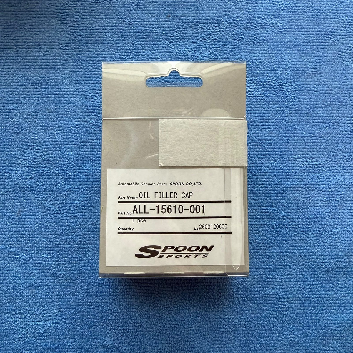 Back of the Spoon Sports packaging showing the genuine parts label, part number ALL-15610-001 oil filler cap