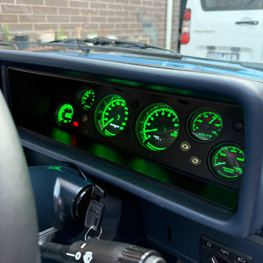Instrument Cluster Replacement with green illuminated gauges and a blurred background