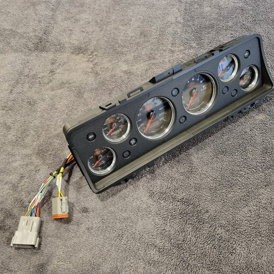 Car dashboard gauge cluster (Instrument Cluster Replacement) with wiring on a gray surface