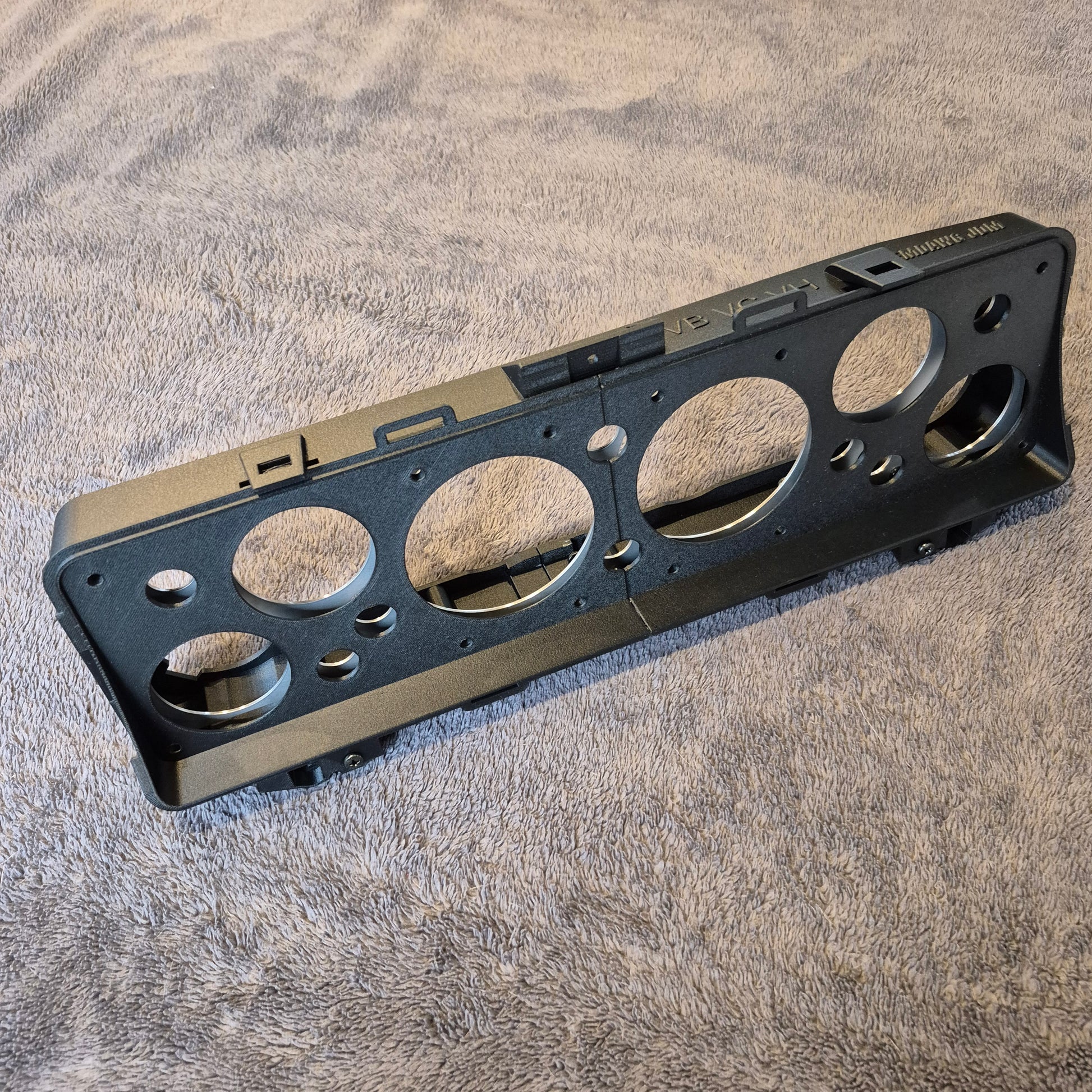 Black metal bracket on a textured gray surface