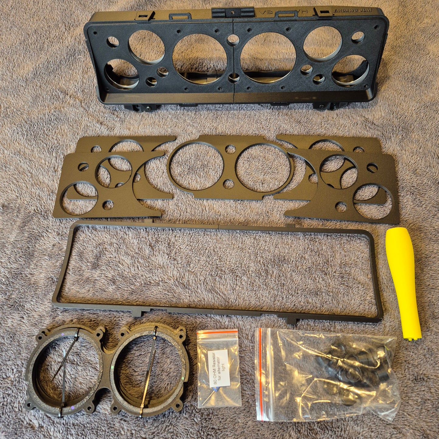 Engine gasket set with tools and packaging on a textured surface