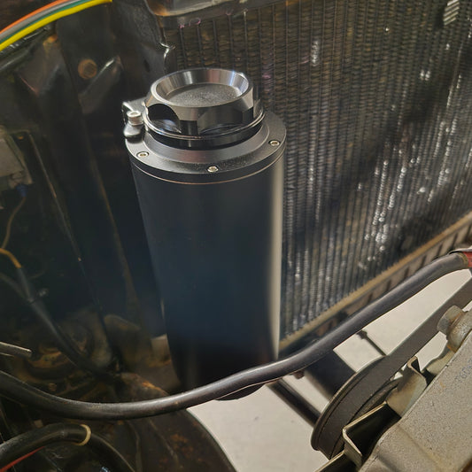 Close-up of a car's SAAS Water Overflow Tank, radiator and cooling system