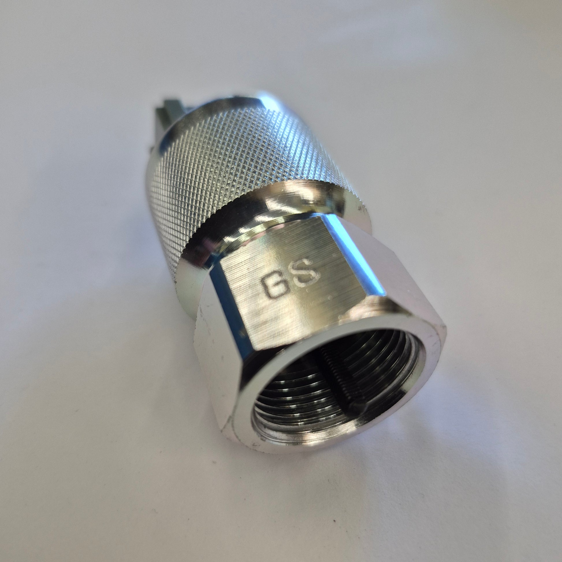 Metal fitting with threading on a white background