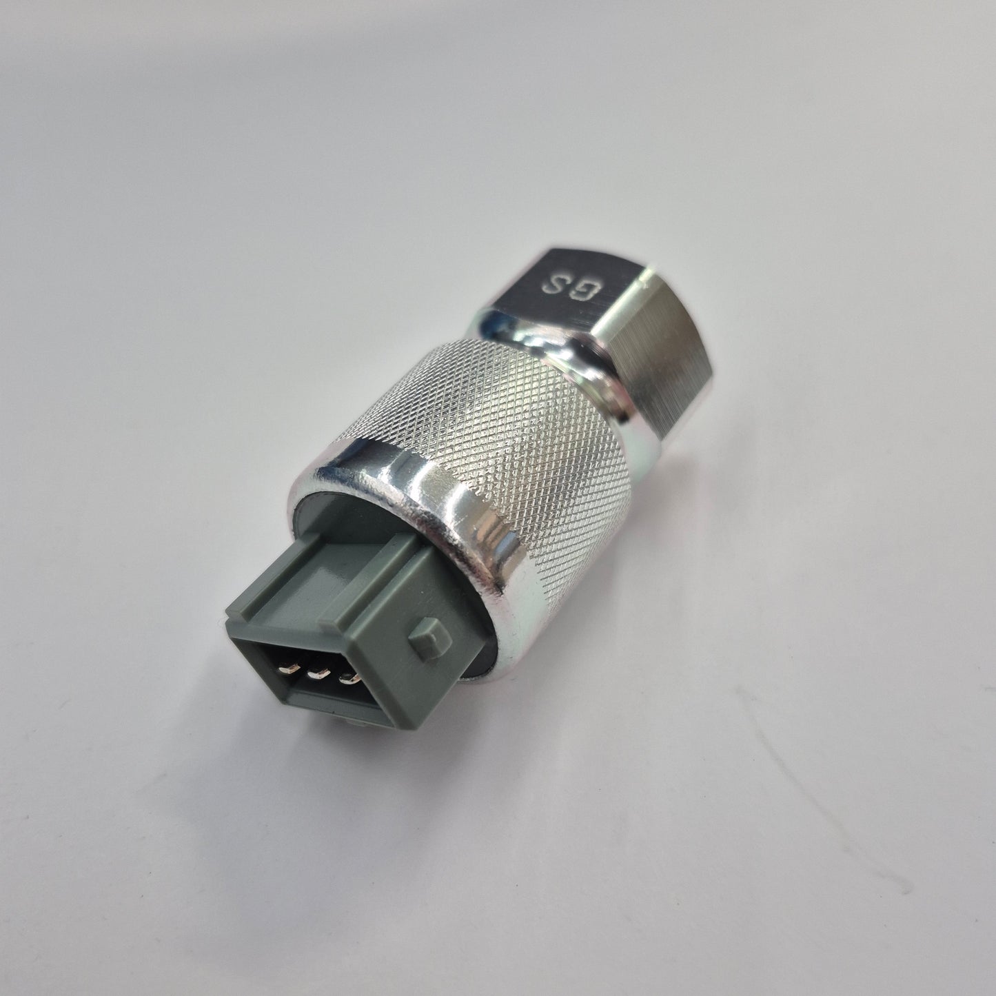 Metallic fitting with a gray connector on a white background