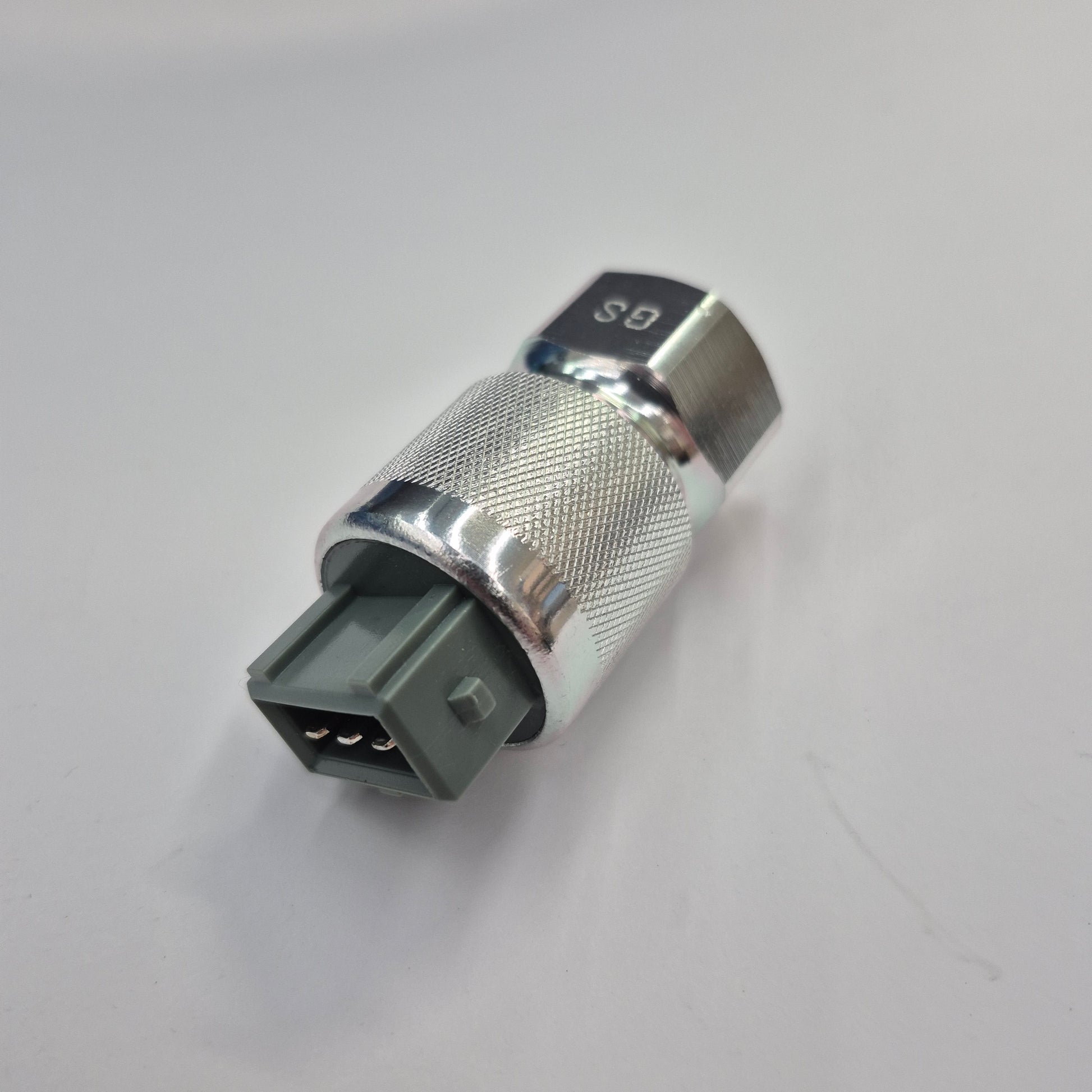Metallic fitting with a gray connector on a white background