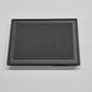 Black rectangular air filter on a light gray background