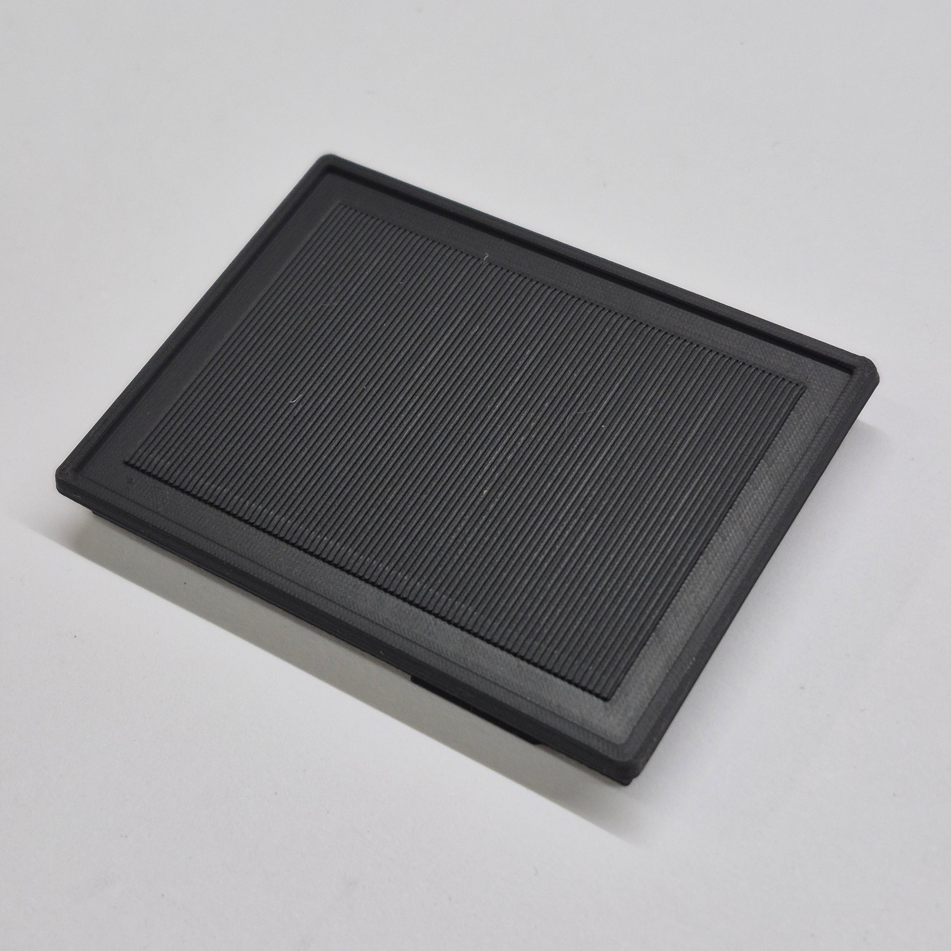 Black rectangular solar panel on a light gray background