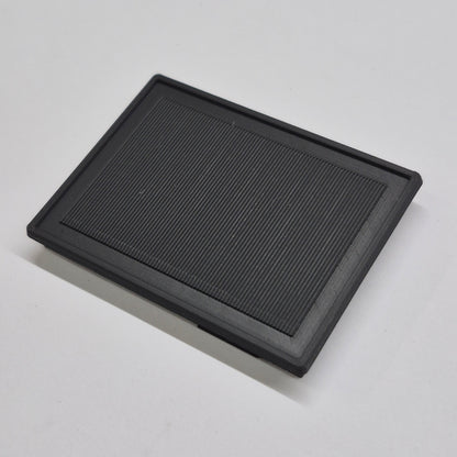 Black rectangular solar panel on a light gray background