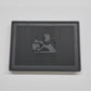Black rectangular mat with a lion emblem on a gray background
