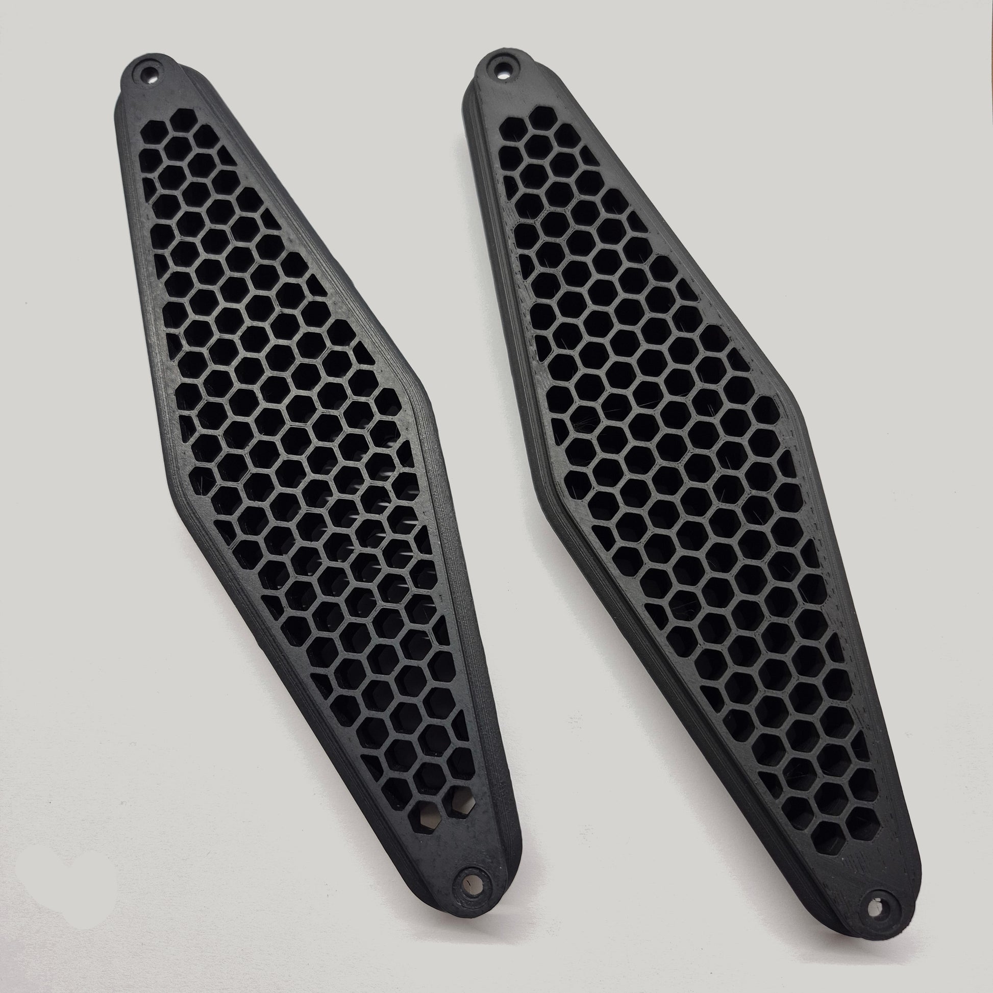 Two black honeycomb-patterned on a white background