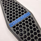 A close-up of a black honeycomb-patterned textured pad with a blue raised 'SANDMAN' logo, shown on a white background.