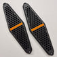 Two black honeycomb-patterned sandboard/skating pads with orange 'SANDMAN' branding, displayed on a light gray background.