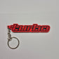 A red and black 'turbo' keychain with a silver metal split ring and chain, photographed on a plain light gray background.