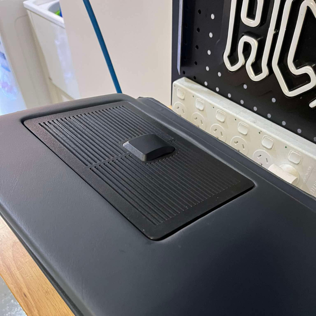 Black tray on a kitchen counter with a blurred background