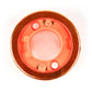 Close-up of a circular object with a red glow on a white background