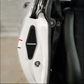 Close-up of a white vehicle door panel with a black mesh speaker grille labeled SANDMAN, next to a black leather seat.