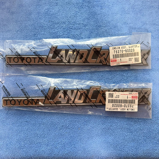 Pair of genuine Toyota LandCruiser 60 Series TOYOTA LAND CRUISER side emblems 75370-60020, new in Toyota Genuine Parts bags