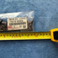 Close-up of Toyota Genuine Parts label EMBLEM ASSY QUARTER 75370-60020 Made in Japan on LandCruiser emblem